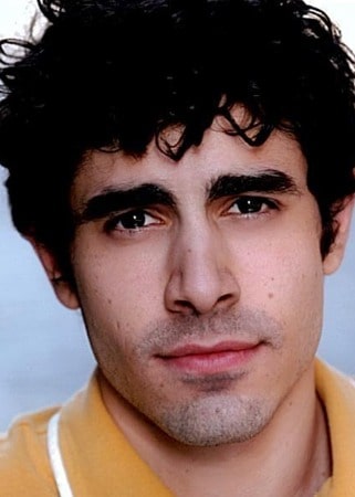 Damon Daunno posing by wearing yellow vest.